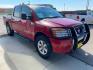2010 Red Nissan Titan SE (1N6AA0EC2AN) with an 5.6L V8 317hp 385ft. lbs. engine, Automatic transmission, located at 842 E South Street, Powell, WY, 82435, (307) 754-7289, 44.752300, -108.746933 - Photo#1